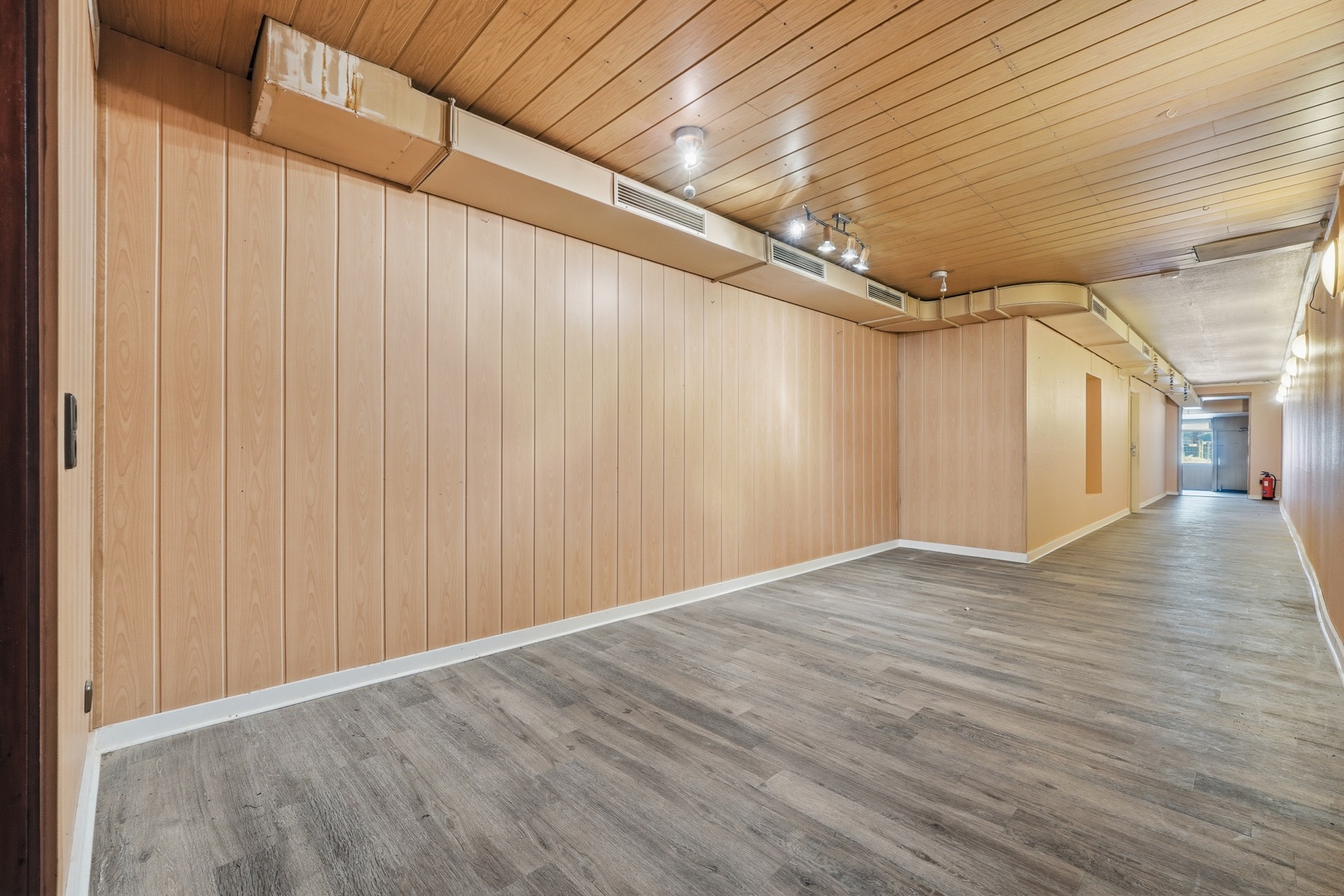 Main room with wood panelling and a new floor